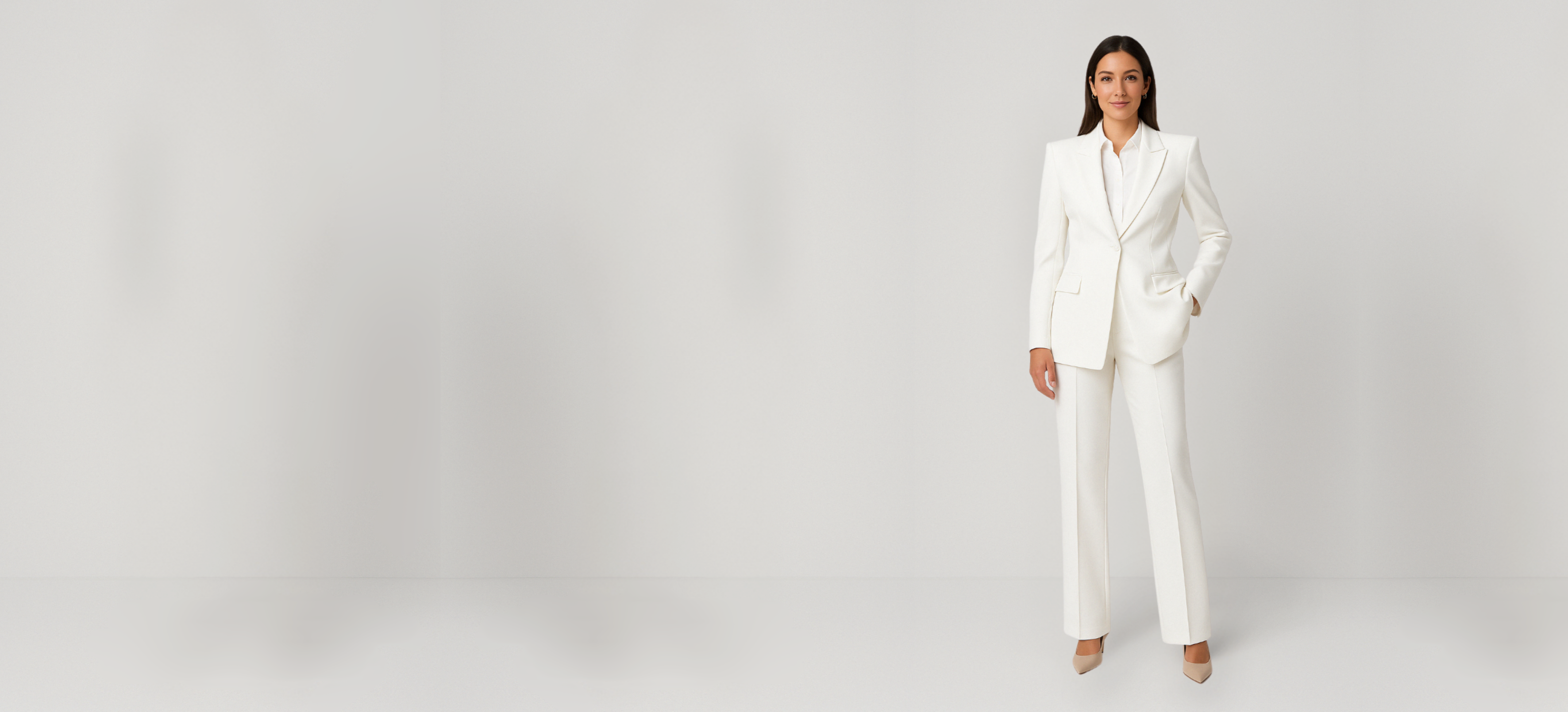 Empowered woman in luxury women’s professional fashion, wearing a tailored white blazer – House of Roy workwear.